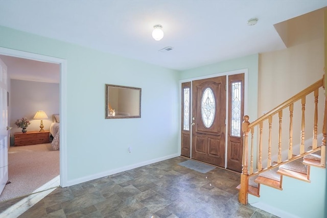 foyer with dark colored carpet