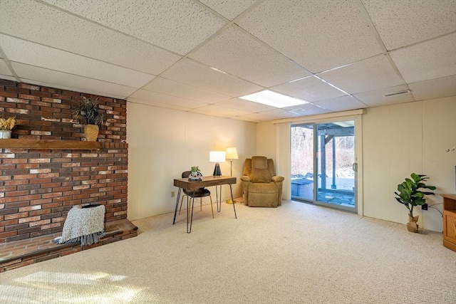 sitting room with a paneled ceiling and carpet floors