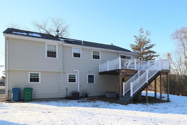 snow covered property featuring a deck and central air condition unit