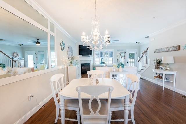 dining space featuring ceiling fan with notable chandelier, dark hardwood / wood-style floors, and a healthy amount of sunlight