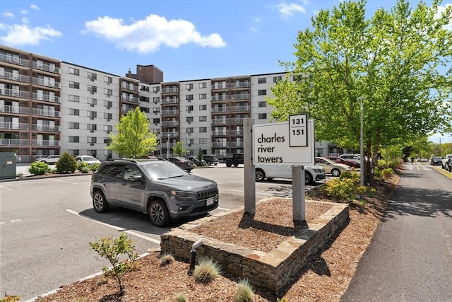 view of apartment building / complex featuring uncovered parking