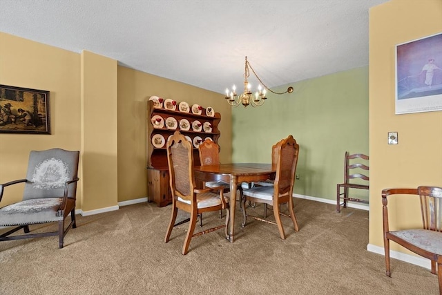 carpeted dining area with a chandelier and baseboards
