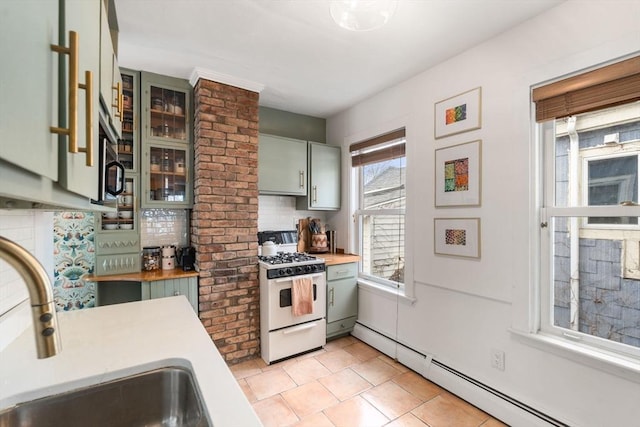 kitchen with a baseboard radiator, glass insert cabinets, white gas stove, wooden counters, and a sink