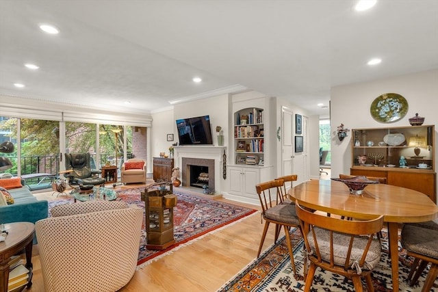 interior space featuring ornamental molding, a wealth of natural light, recessed lighting, and wood finished floors