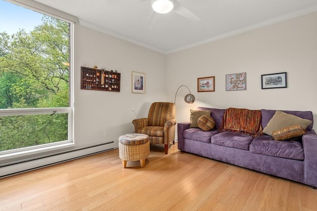 living room with a ceiling fan, crown molding, hardwood / wood-style floors, and baseboard heating