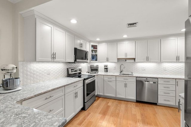 kitchen with white cabinetry, visible vents, appliances with stainless steel finishes, and a sink