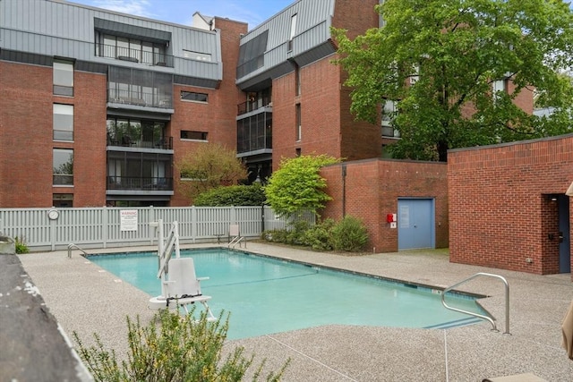 pool with fence and a patio