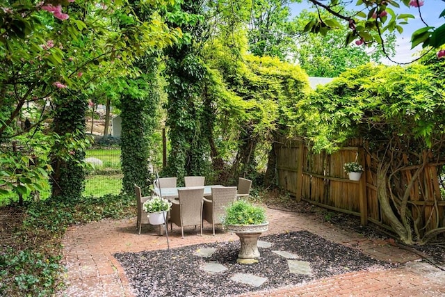 view of patio featuring fence and outdoor dining space