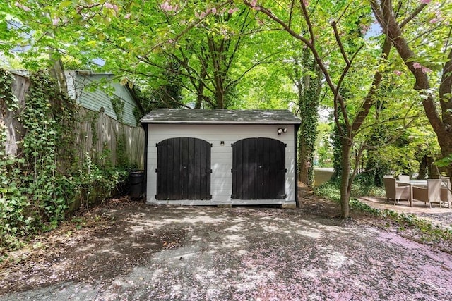 view of shed featuring fence