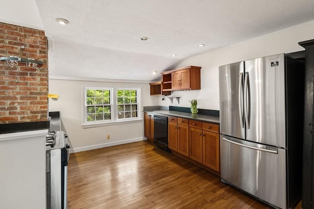 kitchen featuring stainless steel appliances, open shelves, hardwood / wood-style flooring, brown cabinets, and lofted ceiling