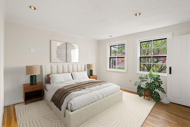 bedroom featuring wood-type flooring, baseboards, and recessed lighting