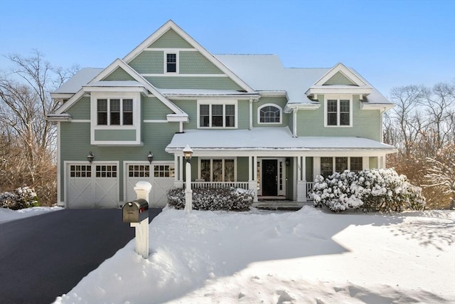 view of front facade with a porch and a garage