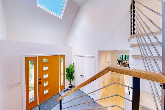 32 Garvey Rd, Framingham, MA 01701 - foyer entrance with high vaulted ceiling, a skylight, and stairs