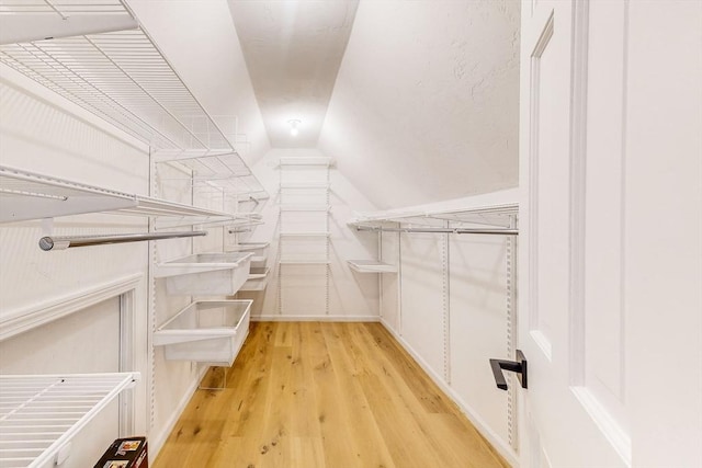 32 Garvey Rd, Framingham, MA 01701 - spacious closet featuring light wood-style flooring and vaulted ceiling