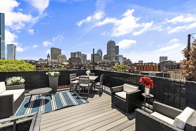 265 Beacon St Unit 5, Boston, MA 02116 - deck featuring outdoor dining space, a view of skyline, and an outdoor living space