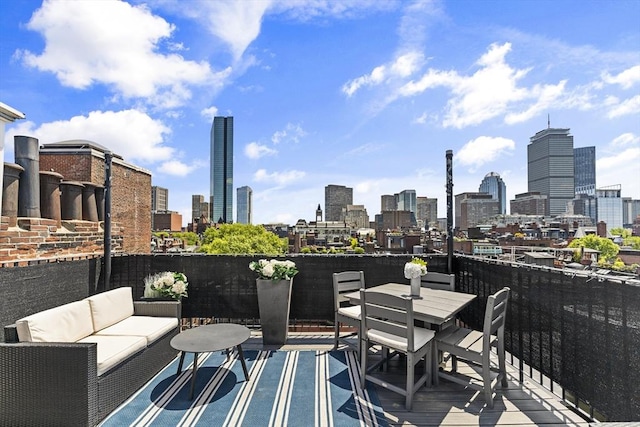 265 Beacon St Unit 5, Boston, MA 02116 - view of patio with an outdoor living space, a skyline view, and outdoor dining area