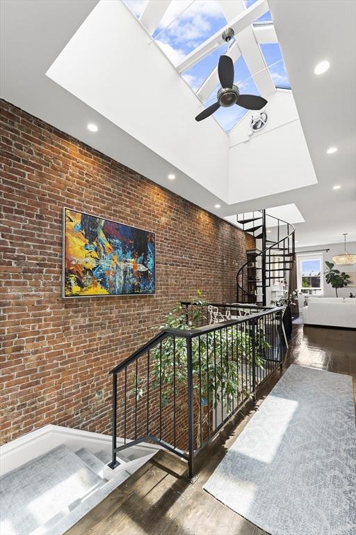 265 Beacon St Unit 5, Boston, MA 02116 - corridor featuring wood finished floors, a towering ceiling, brick wall, and recessed lighting