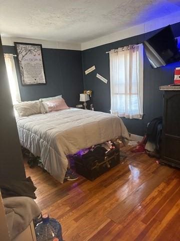 bedroom featuring wood-type flooring and a textured ceiling