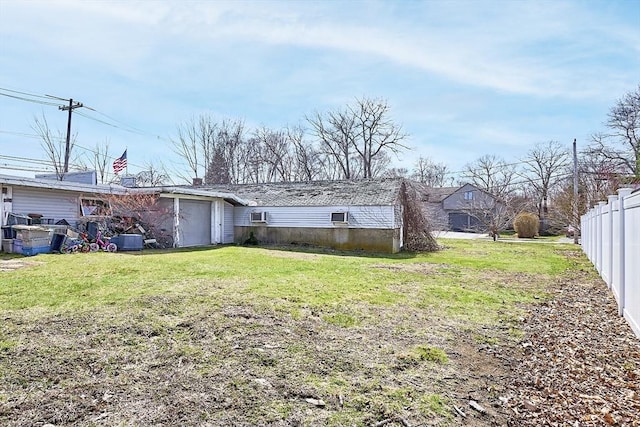 back of house featuring fence and a lawn