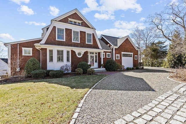 shingle-style home with a front yard and driveway