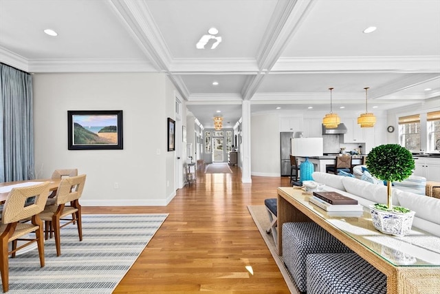 living room with beamed ceiling, recessed lighting, light wood finished floors, and ornamental molding