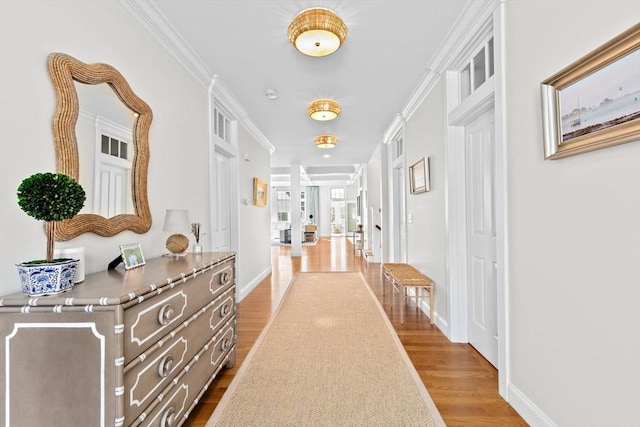 hall featuring ornamental molding, baseboards, and dark wood-style flooring