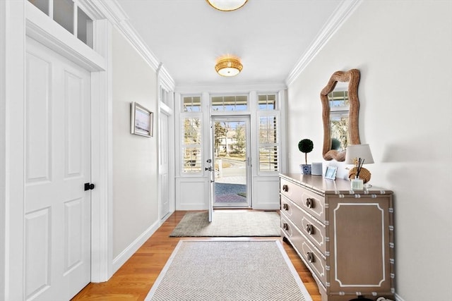 foyer entrance featuring wood finished floors, baseboards, and ornamental molding