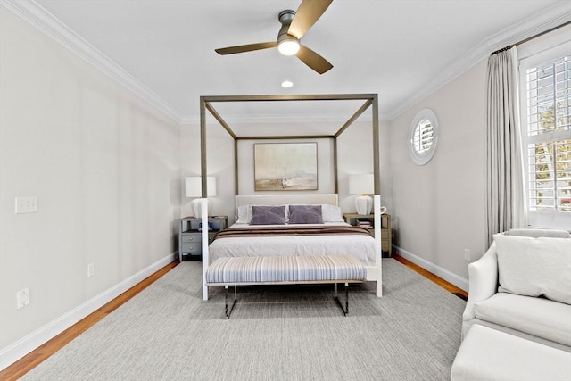 bedroom with wood finished floors, baseboards, and ornamental molding