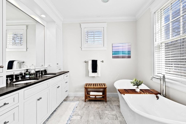 full bathroom with double vanity, a soaking tub, ornamental molding, and a sink