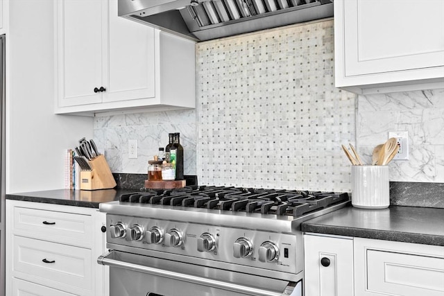 kitchen with custom exhaust hood, white cabinets, stainless steel range, and dark countertops