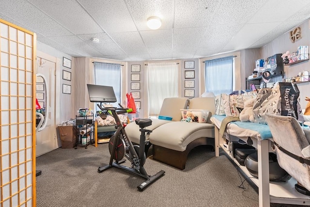 interior space with a drop ceiling and carpet floors