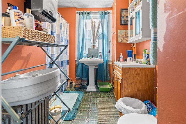 bathroom featuring a paneled ceiling