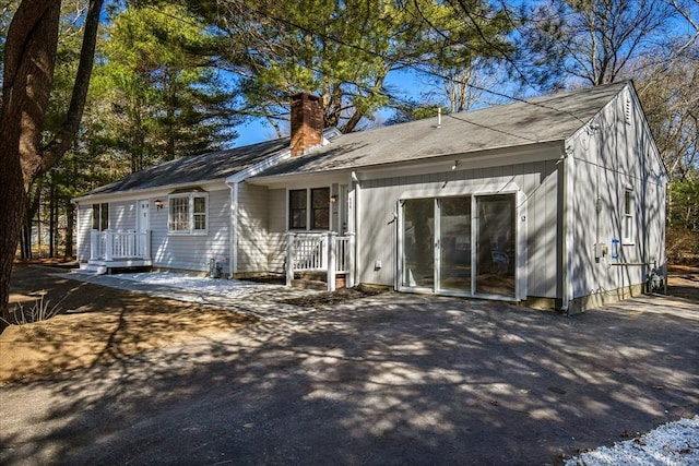 rear view of property with a chimney