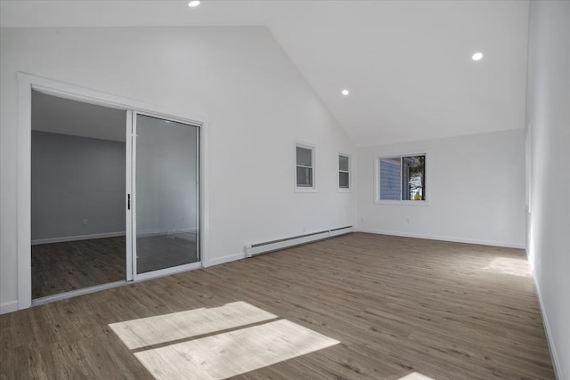 unfurnished room featuring baseboards, baseboard heating, recessed lighting, wood finished floors, and high vaulted ceiling