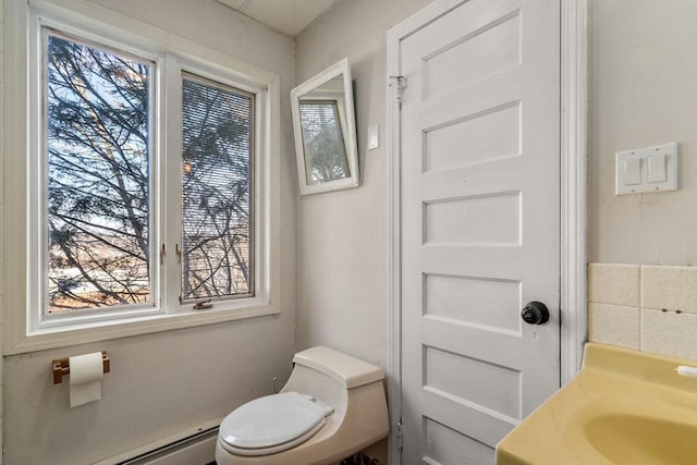 bathroom featuring toilet and baseboard heating