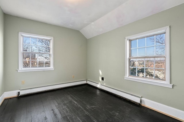 spare room with baseboards, a baseboard heating unit, dark wood-type flooring, and vaulted ceiling