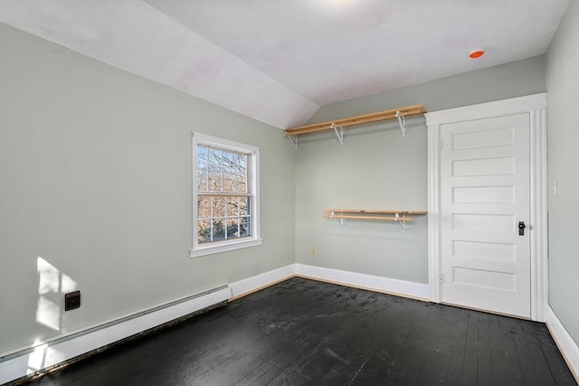 walk in closet featuring lofted ceiling, dark wood-style floors, and baseboard heating