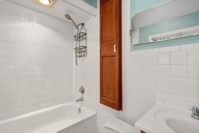 full bathroom featuring shower / bath combination, toilet, tile walls, and vanity