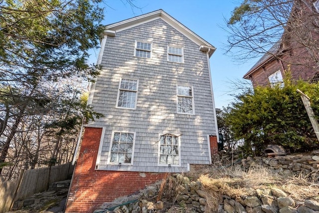 view of home's exterior with fence