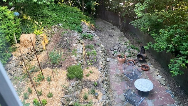 view of yard featuring a patio area, an outdoor fire pit, and fence