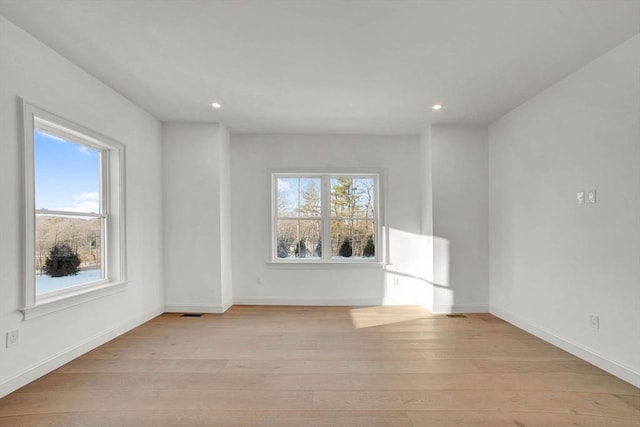 spare room featuring light hardwood / wood-style flooring