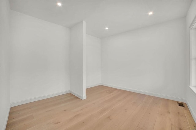 unfurnished room with light hardwood / wood-style floors