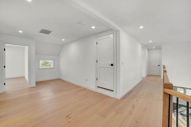 interior space featuring vaulted ceiling and light hardwood / wood-style flooring