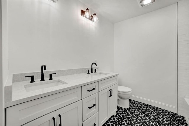 bathroom with toilet and vanity