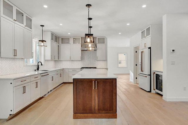 kitchen with premium range hood, white appliances, a kitchen island, and hanging light fixtures