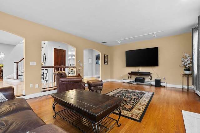 231 Manns Dr, Hanover, MA 02339 - living area with baseboards, arched walkways, and wood finished floors