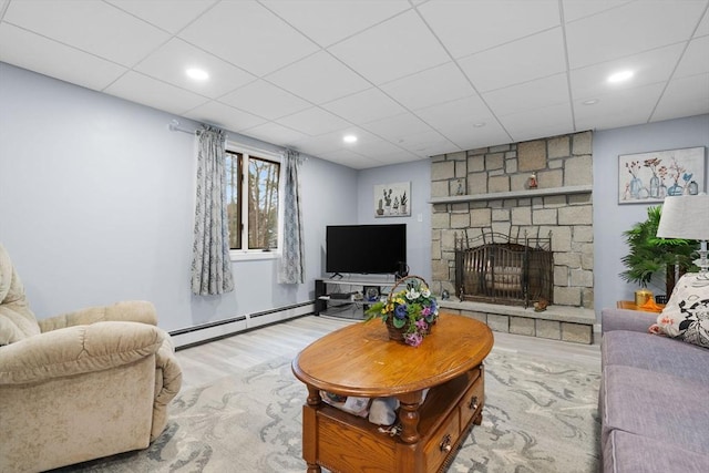 231 Manns Dr, Hanover, MA 02339 - living room featuring a fireplace, a paneled ceiling, wood finished floors, and a baseboard radiator