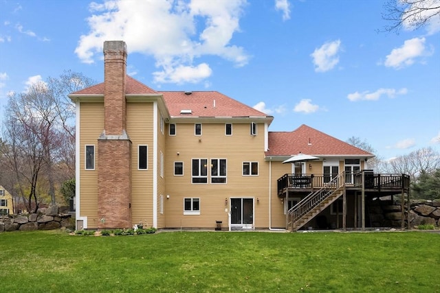 231 Manns Dr, Hanover, MA 02339 - rear view of house featuring a lawn, stairway, a chimney, and a wooden deck