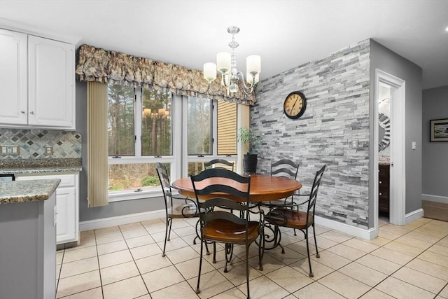 231 Manns Dr, Hanover, MA 02339 - dining area with light tile patterned floors, a notable chandelier, and baseboards