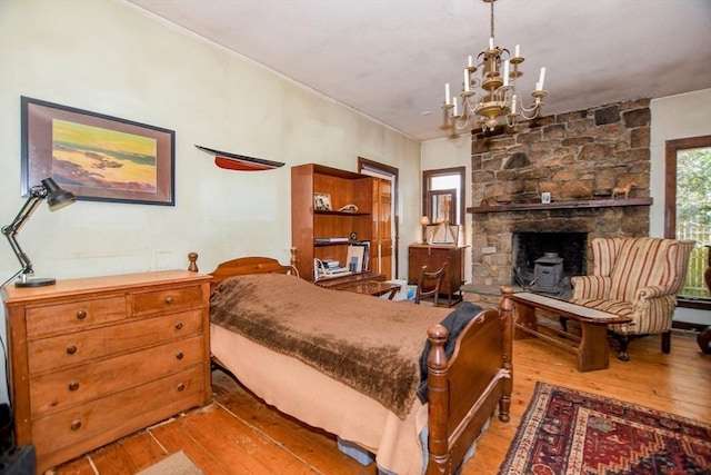 bedroom featuring light wood-type flooring and a chandelier